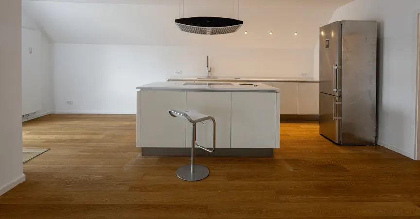 Leere offene Küche mit Kochinsel vor dem Home Staging